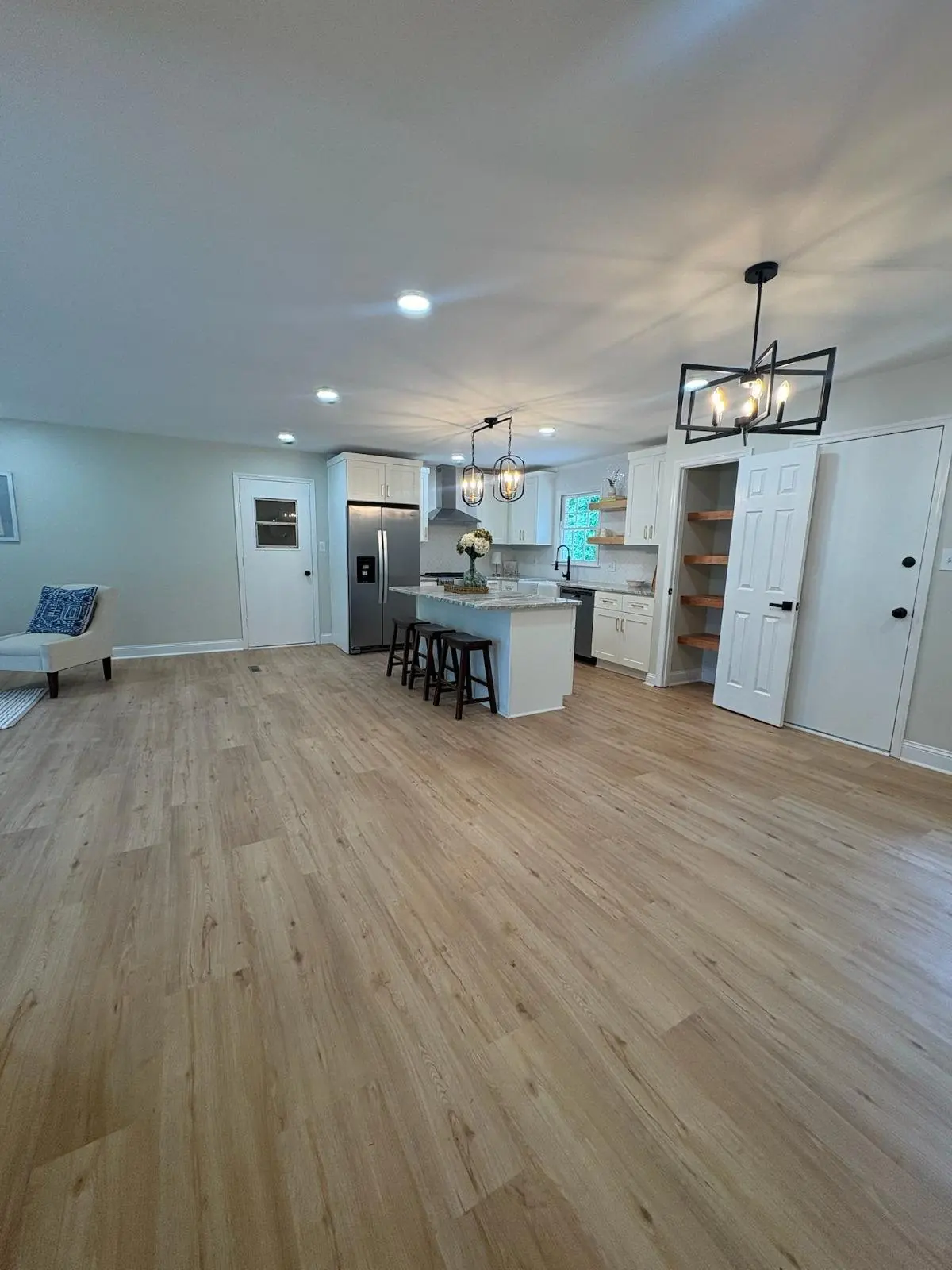 Open kitchen and living space with light oak floors