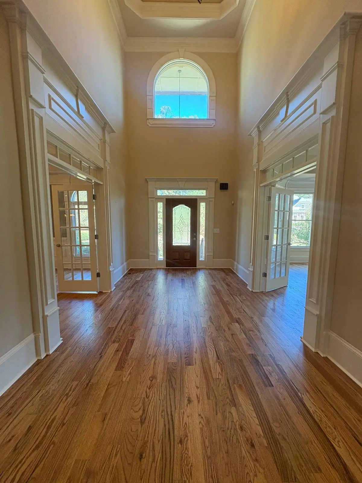 Foyer with a finished hardwood floor and an arched window