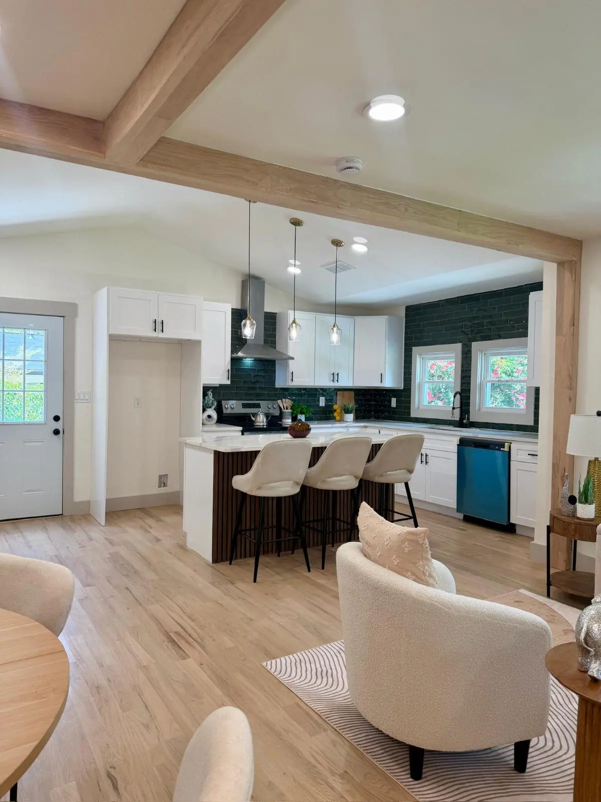 Kitchen and dining area with light oak floors and wood beams